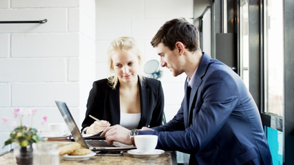 Man is Showing Something on His Laptop Computer
