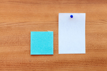 blue sticker with a white paper isolated on a wooden background