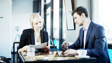Businesswoman Explains Something to Her Partner