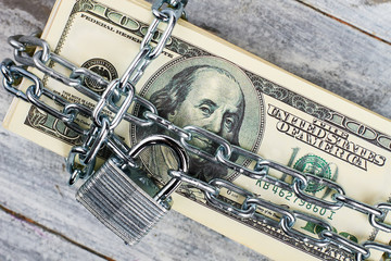 Dollars wrapped in a chain. Get rid of financial dependence.