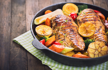 Grilled chicken breast and vegetables in the pan 
