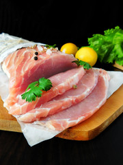Fresh sliced pork carbonade on a wooden board 