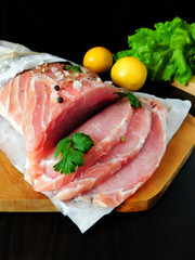 Fresh sliced pork carbonade on a wooden board 