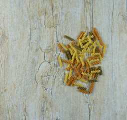 Fototapeta premium colored pasta on a wooden table