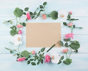 Wooden background with floral frame consists of roses and orchid flowers