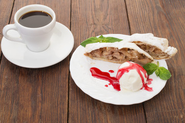 apple strudel with ice cream and a cup of coffee