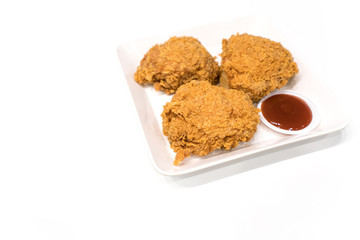 fried chicken thigh and Ketchup on a white plate - isolate white background with copy space.