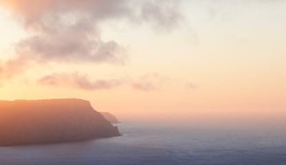 Naklejka na ściany i meble Dawn above the sea coast