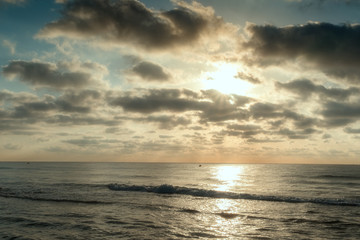 Naklejka na ściany i meble Sunrise on the beach and clouds