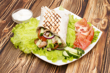 Shawarmas on lettuce isolated a wooden background
