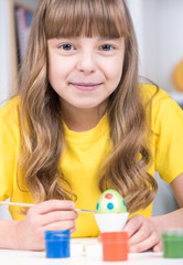 Easter holiday - kid coloring eggs