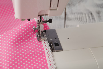 foot of sewing machine with polkadot clothes