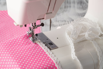 Leisure hobby concept, sewing machine at home with pink polkadot