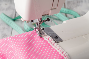 Leisure hobby concept, sewing machine at home with pink polkadot
