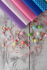 Leisure for woman concepr. Beads on table with sewing utencils