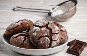 Homemade chocolate cookies with cracks. Biscuits with icing sugar.  Selective focus
