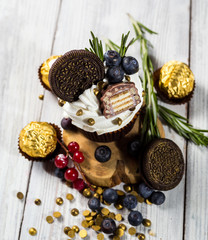 Chocolate cupcakes.Cupcakes with berries,fruit,strawberries. Top view.colorful cupcake,tasty cake,colorful cream,candies,cupcakes with summer berries on wooden background,close up,dessert concept