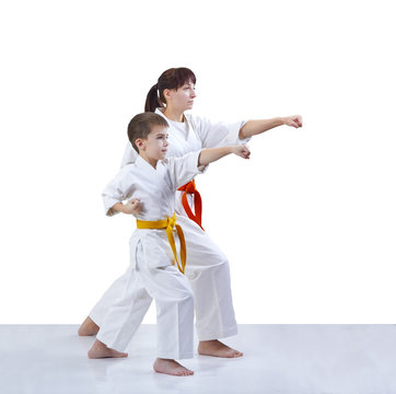 With yellow and orange belt the mother and son are hitting a punch arm