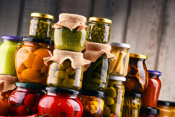 Jars with variety of pickled vegetables.