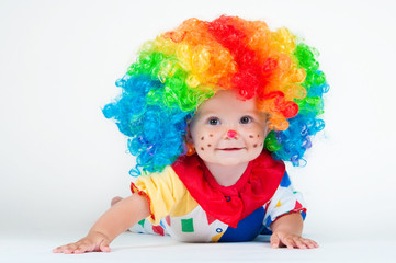 Child clown with a red nose multicolored wig in with balls