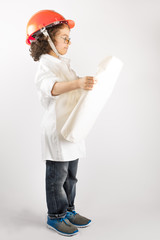 Young curly foreman looking at the drawing. Gray background.