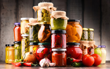 Jars with variety of pickled vegetables.