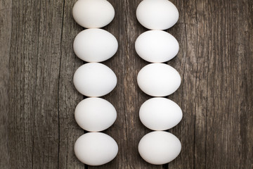 Chicken eggs in row on wooden rustic table.  Top view and flat lay. Concept.