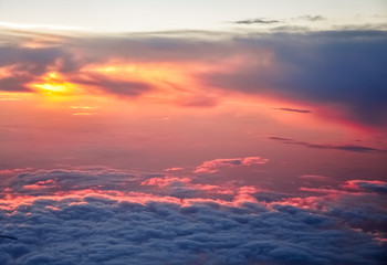 Beautiful pink and orange clouds at dawn morning sunlight. View from the plane