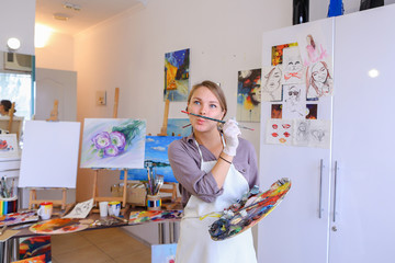 Women beautiful painter posing and smiling, laughing into camera