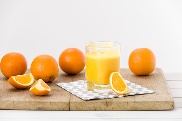 Obraz na płótnie Canvas Freshly prepared orange juice, white background
