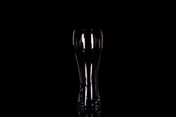 Empty beer glass on black background