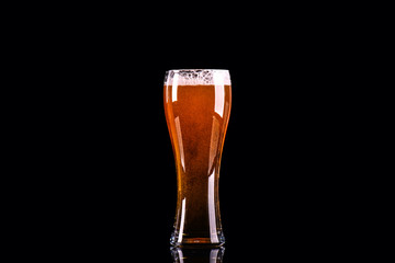 Beer glass with foam on black background