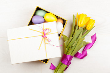 Colorful Easter Eggs and tulips decorated in beautiful giftbox