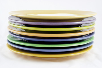 Side view of rims of colorful handmade ceramic plates. Isolated.
