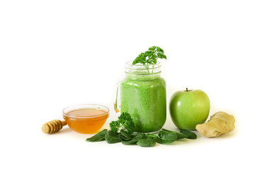 Green vegetable smoothie from spinach, parsley, apple, ginger and honey.
