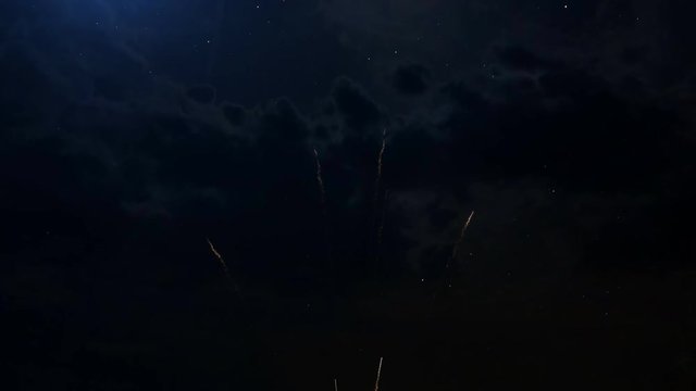 Happy birthday Anniversary 25 years celebration greeting text with particles and sparks on black night sky with colored slow motion fireworks on background, beautiful typography magic design.