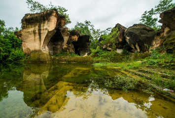 nature outdoor park with pond water in limestone mining hill ancient work place at bukit kapur. indonesia