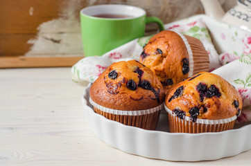 Blueberry muffins on wooden vintage background. Selective focus