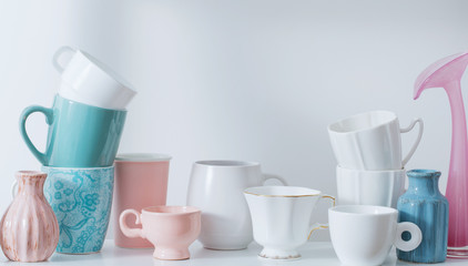Clean dishes and flowers on wooden shelf