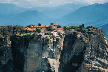 View of The Holy Monastery of St. Stephen on the rock at the complex of Meteora monasteries in Greece. Steep cliffs and mountains in the valley of Thessaly - obrazy, fototapety, plakaty