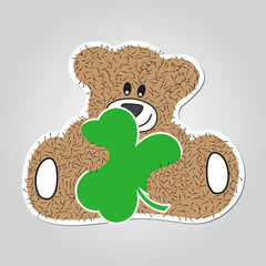 cartoon - brown, furry smiling bear with clover