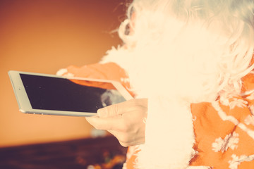 Busy Santa Claus using mobile device, closeup on hands