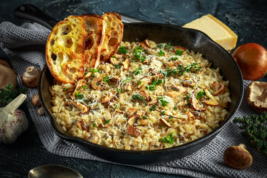 Mushroom Risotto in iron pan with herbs and parmesan cheese