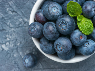 Blueberries in spoon on dark background
