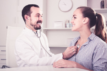 Smiling woman patient with male doctor