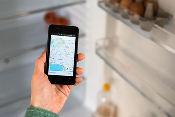 Person Hands Holding Smart Phone and searching for places to eat