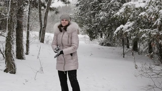 Winter joyful woman throwing snowballs happiness outdoors
