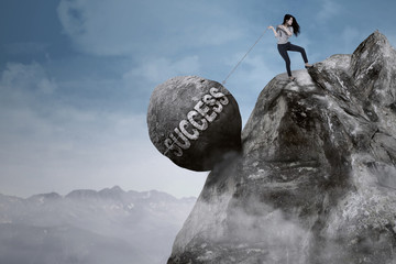 Businesswoman pulls success word on the mountain