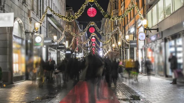 Busy shopping street with Christmas decorations Time Lapse. People passing by, Stockholm city center downtown, Sweden