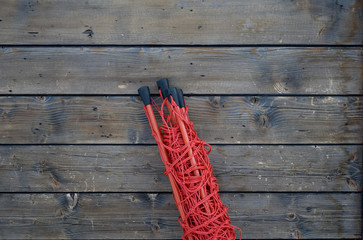Old wood Background and security red rope net, put to the edges of the ski slopes as for safety in case of danger, used to prevent falls and accidents, Trentino Alto Adige, Dolomiti, Italia